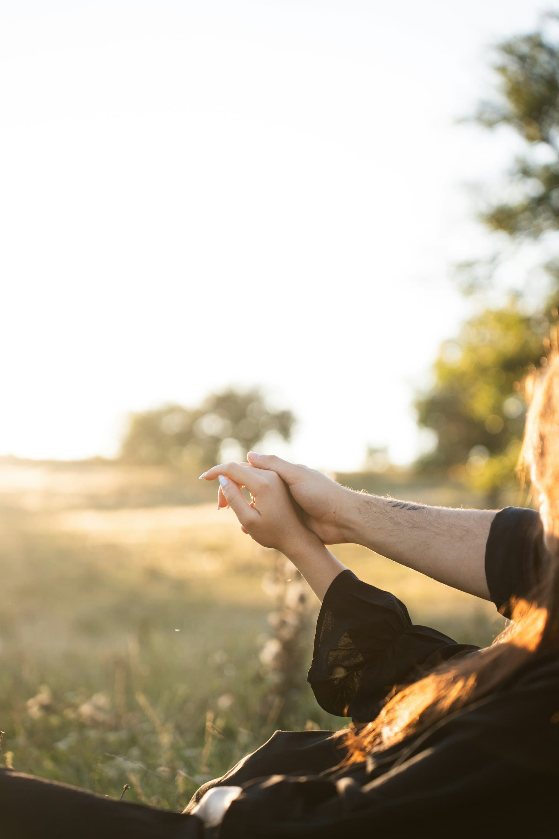 Couple holding hands in golden sunlight